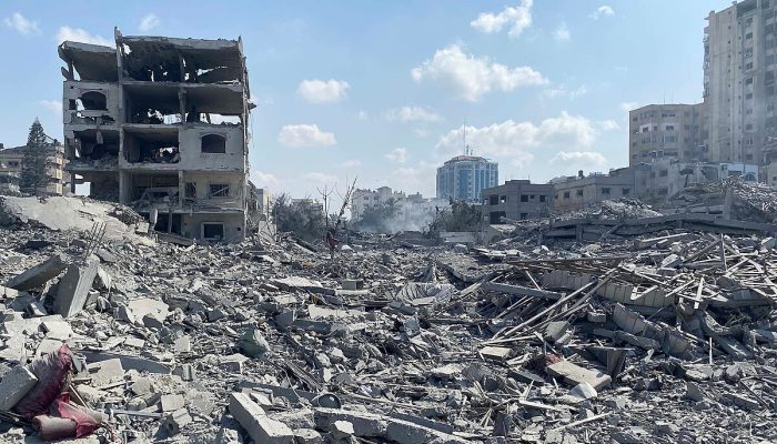 Palestinians inspect the damage following an Israeli airstrike on the El-Remal aera in Gaza City on October 9, 2023. Israel continued to battle Hamas fighters on October 10 and massed tens of thousands of troops and heavy armour around the Gaza Strip after vowing a massive blow over the Palestinian militants' surprise attack. Photo by Naaman Omar apaimages